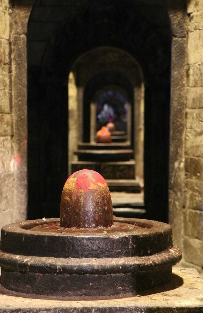 Multiple Shiva lingas aligned in the ancient Pashupatinath Temple, Kathmandu, Nepal.